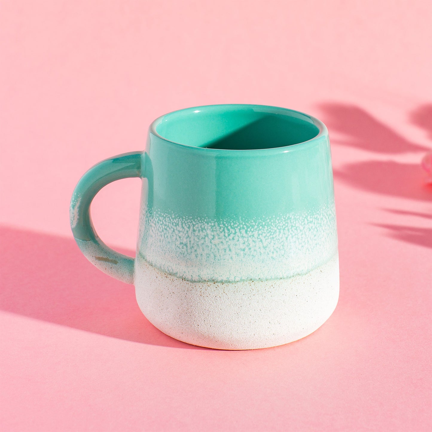 Mint green mug on pink background – lifestyle setting
