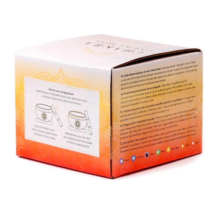 Back of chakra singing bowl packaging with multilingual usage instructions and illustrations explaining how to use the singing bowl.