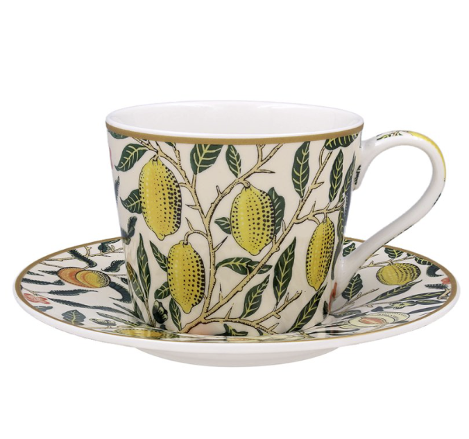 Close-up of The Leonardo Collection cup and saucer with detailed yellow fruits and green leaves on cream background.