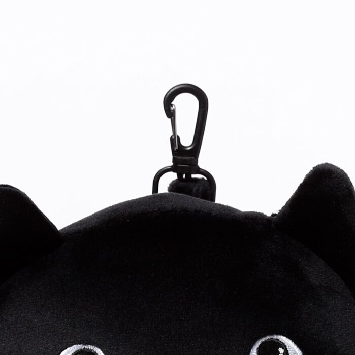 Close-up of travel clip attachment on cat plush pillow