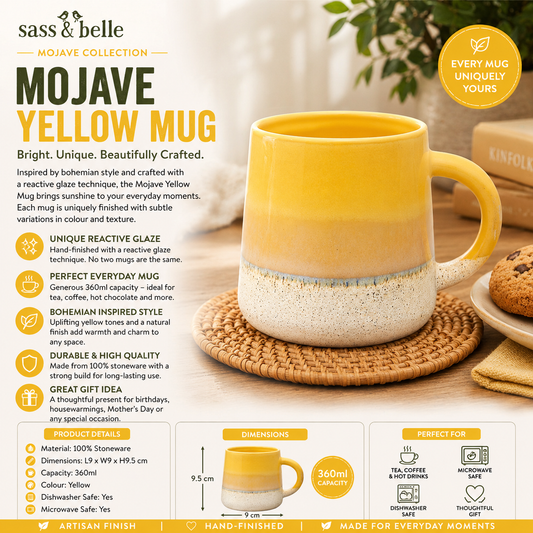 Yellow mug with white base on a wooden surface, surrounded by cookies and plants, featuring sass & belle branding.