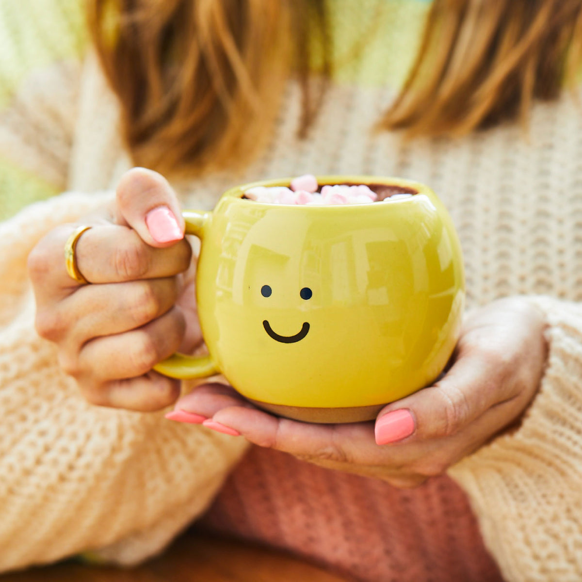 Cute yellow stoneware mug with marshmallows