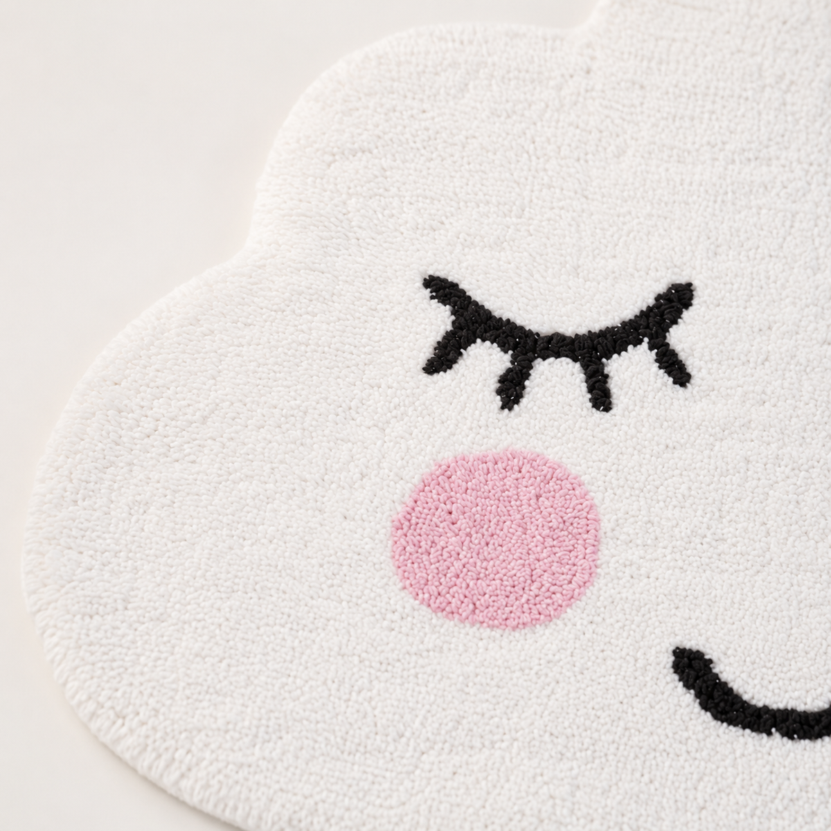 Close-up of white cotton texture and smiling face on Sass & Belle cloud rug