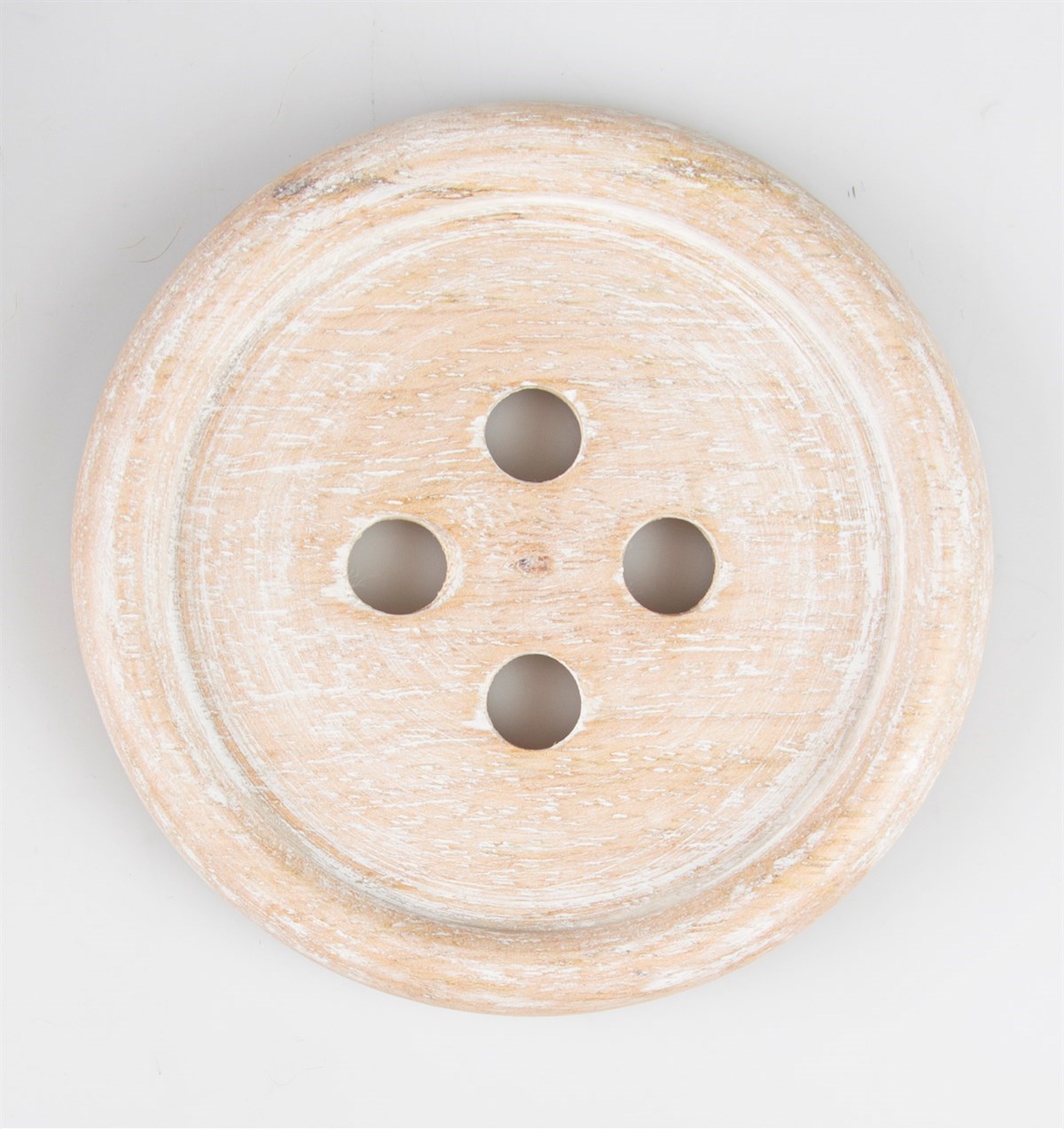 Rustic wooden button shaped coaster close up top view