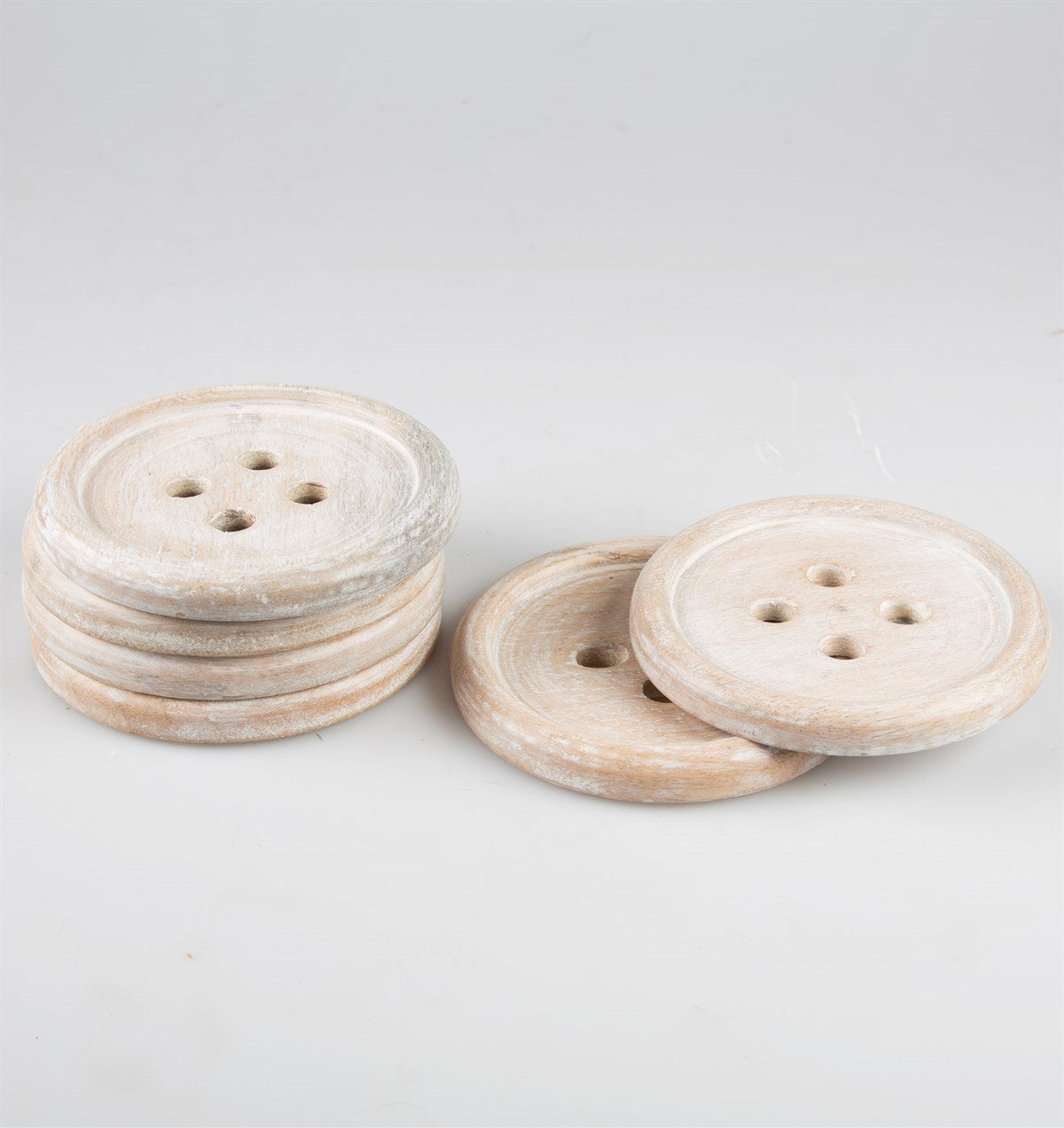 Wooden button coaster set stacked on table