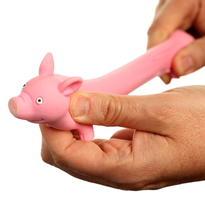 Hand stretching the squeezy pig toy showing stretchy texture